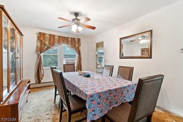 dining area featuring a baseboard heating unit, light colored carpet, and ceiling fan