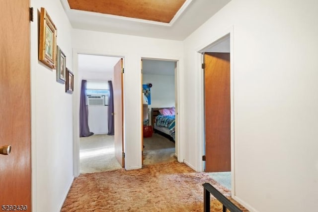 hallway with carpet floors and cooling unit