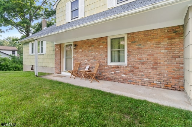 entrance to property with a lawn