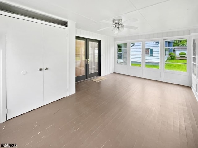 unfurnished sunroom featuring french doors and ceiling fan