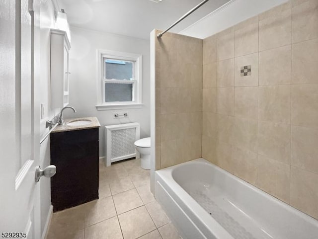 full bathroom featuring radiator, tiled shower / bath combo, tile patterned flooring, toilet, and vanity