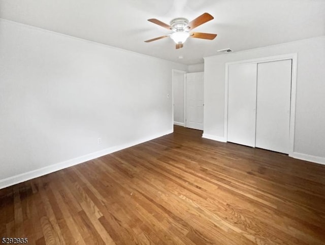 unfurnished bedroom featuring wood-type flooring, a closet, and ceiling fan