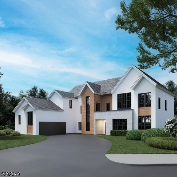 view of front of property featuring a garage and a front yard