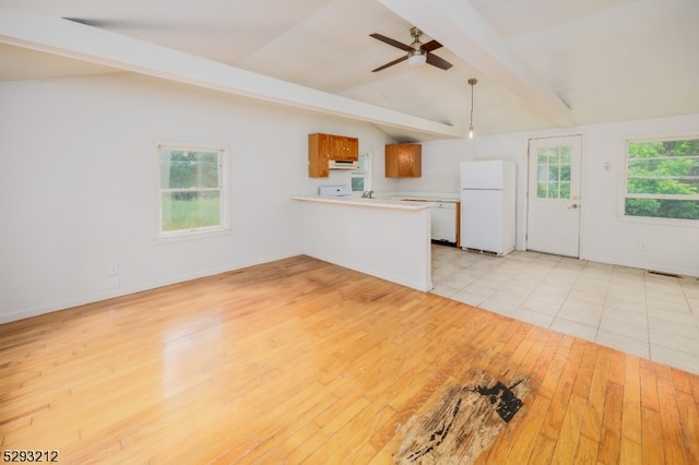 unfurnished living room with ceiling fan, lofted ceiling with beams, and light hardwood / wood-style flooring