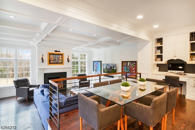 dining space with dark hardwood / wood-style floors, beam ceiling, ornamental molding, and coffered ceiling