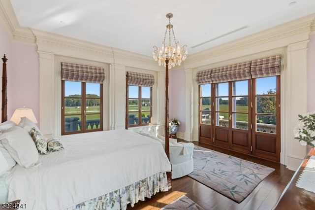 bedroom featuring crown molding, dark hardwood / wood-style floors, multiple windows, and a notable chandelier