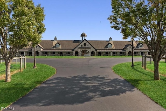 318-322 Rte 537, Colts Neck Twp, NJ 07722 - view of front of house with curved driveway, stone siding, and a front yard