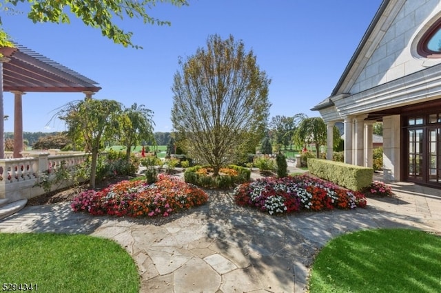 view of terrace with a pergola and french doors