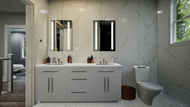 bathroom with dual bowl vanity, toilet, tile floors, and tasteful backsplash