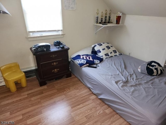 bedroom featuring wood-type flooring and vaulted ceiling