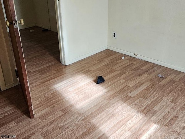 unfurnished room with light wood-type flooring