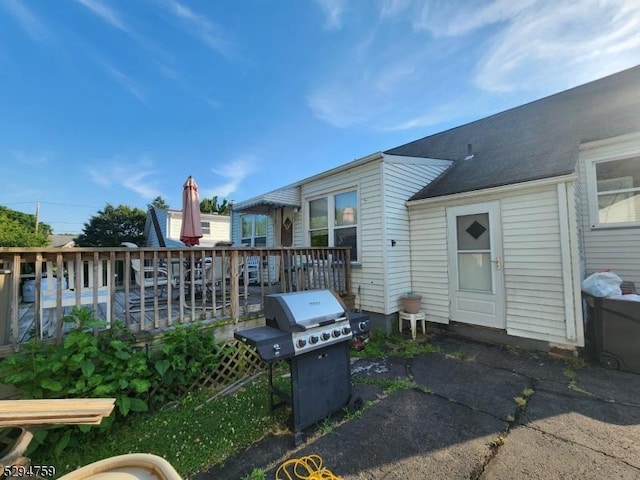 view of patio featuring a grill and a deck