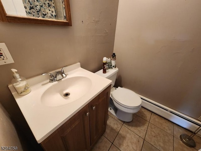 bathroom featuring baseboard heating, vanity, toilet, and tile patterned flooring