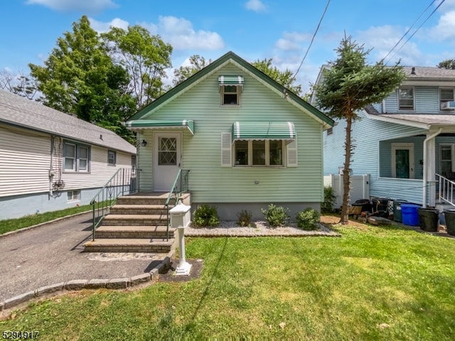 rear view of house with a lawn