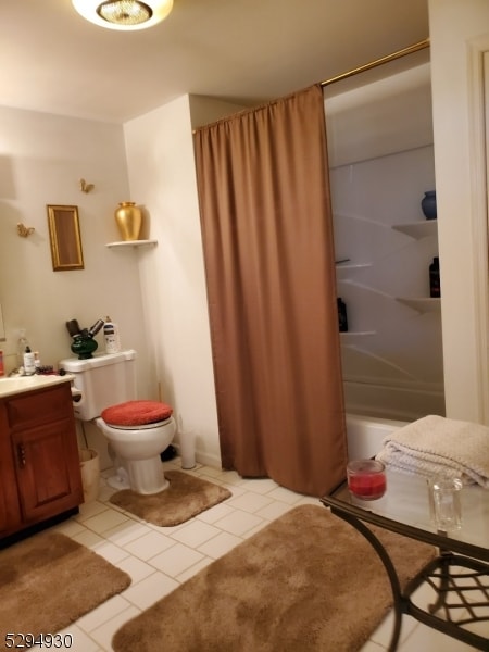 full bathroom featuring shower / bathtub combination with curtain, vanity, toilet, and tile floors