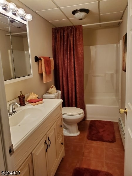 full bathroom with a baseboard radiator, toilet, tile flooring, shower / tub combo, and vanity