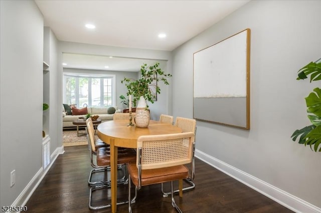 dining area featuring dark wood-type flooring