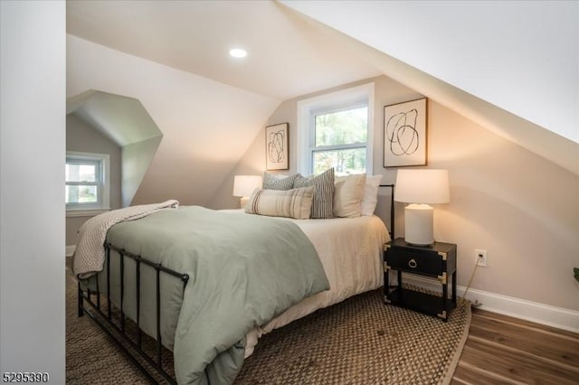 bedroom with vaulted ceiling and dark hardwood / wood-style floors