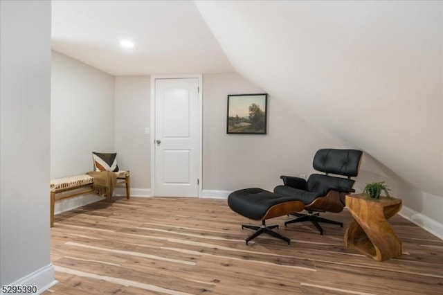 living area featuring lofted ceiling and light wood-type flooring