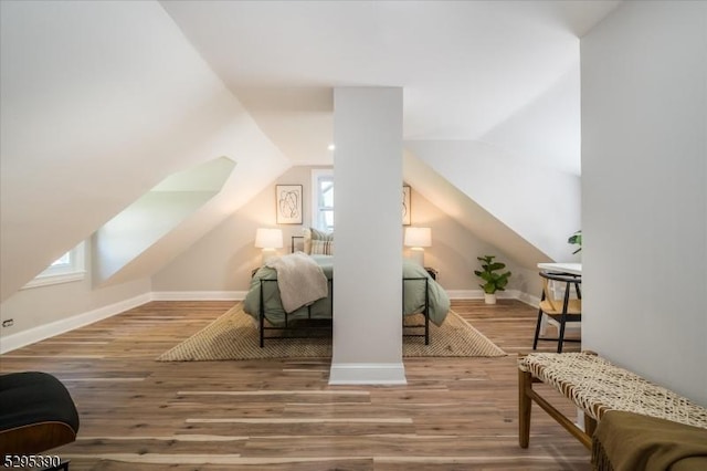 additional living space featuring hardwood / wood-style floors and lofted ceiling