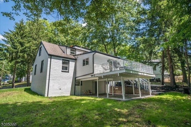 back of house featuring a yard and a wooden deck