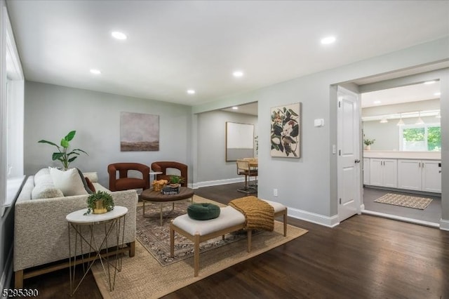 sitting room with dark hardwood / wood-style flooring