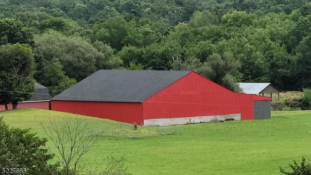 view of outbuilding featuring a yard