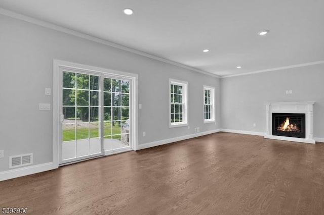 unfurnished living room with ornamental molding and dark wood-type flooring