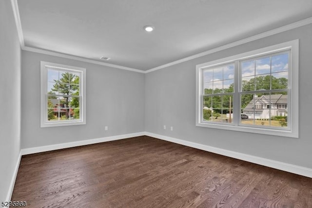 empty room with dark hardwood / wood-style floors and ornamental molding