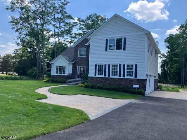 view of front facade featuring a front lawn and a garage