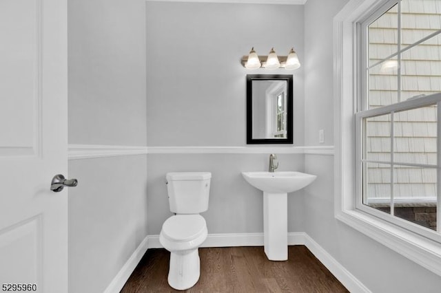 bathroom featuring hardwood / wood-style flooring, plenty of natural light, and toilet