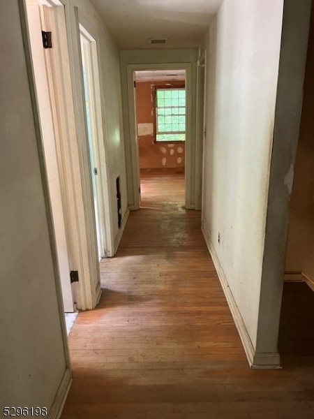 corridor featuring wood-type flooring