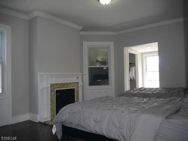 bedroom featuring ornamental molding and dark hardwood / wood-style flooring