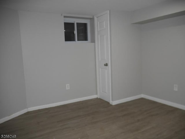 unfurnished room with dark hardwood / wood-style floors