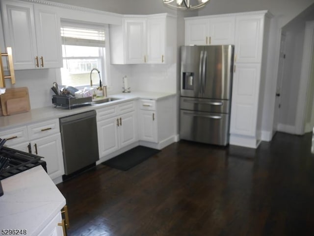 kitchen featuring dark wood-type flooring, white cabinets, appliances with stainless steel finishes, and sink