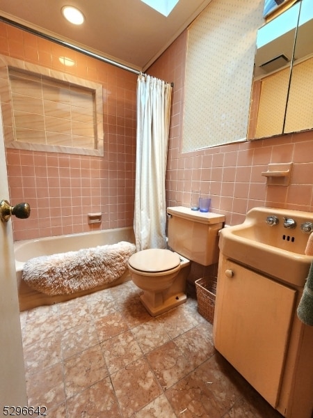 full bathroom featuring tile walls, toilet, tile flooring, shower / tub combo, and vanity