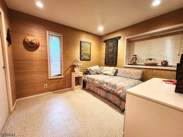 carpeted bedroom with wooden walls