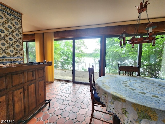 dining area featuring light tile floors