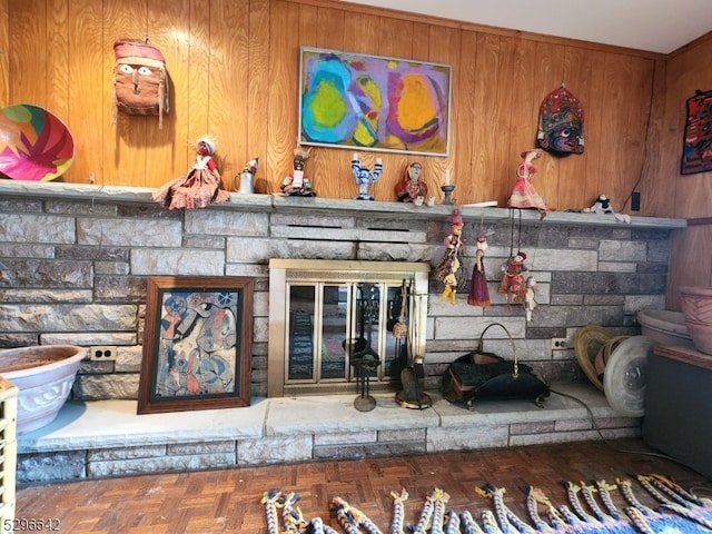 interior details featuring parquet flooring and wood walls