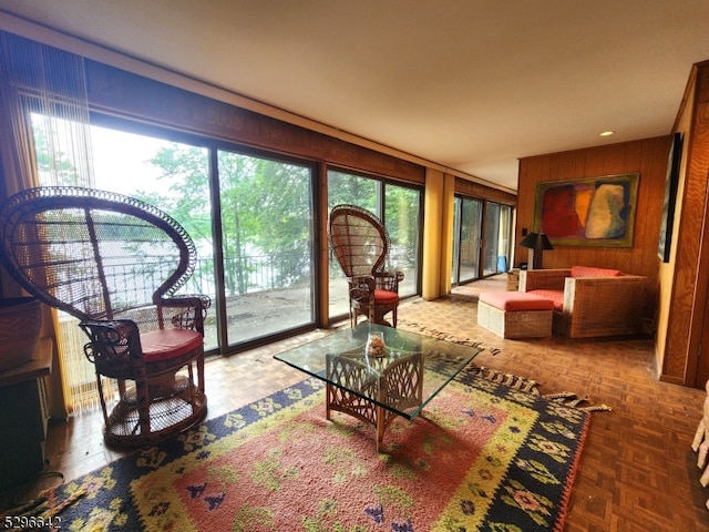 living room with parquet floors and a healthy amount of sunlight