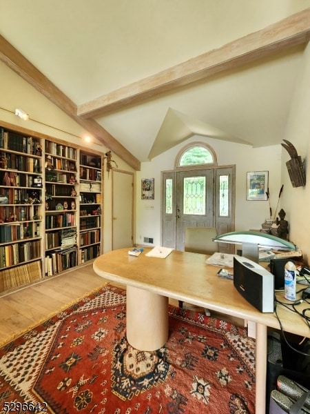 office with wood-type flooring and lofted ceiling with beams