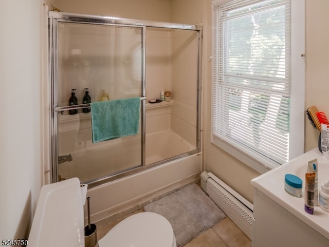 bathroom featuring baseboard heating, combined bath / shower with glass door, toilet, and tile patterned flooring