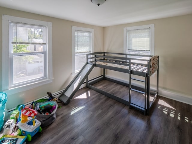 bedroom with dark hardwood / wood-style floors