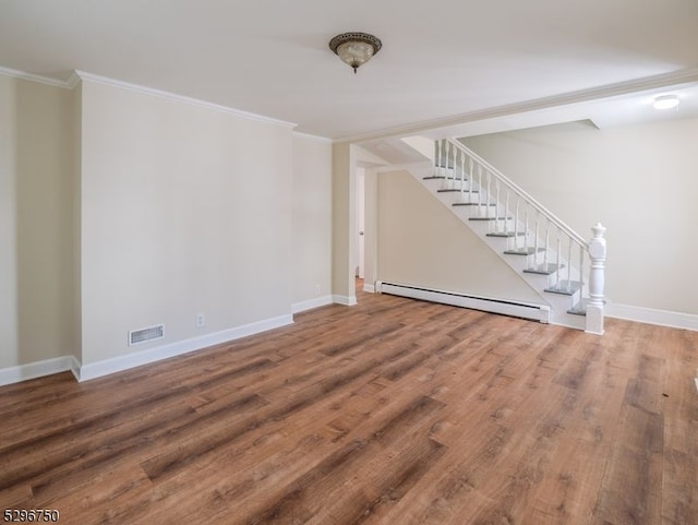 unfurnished living room featuring hardwood / wood-style flooring, ornamental molding, and a baseboard heating unit