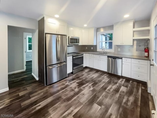 kitchen with sink, white cabinets, a healthy amount of sunlight, and stainless steel appliances