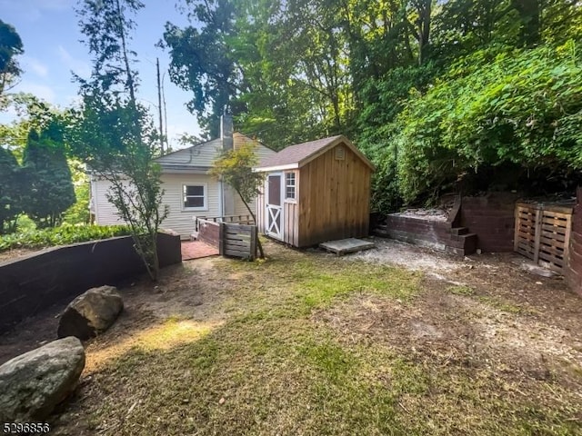 rear view of house featuring a shed