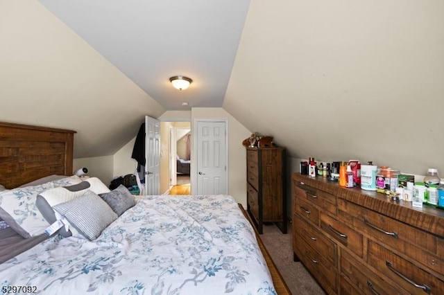 bedroom featuring lofted ceiling and light colored carpet