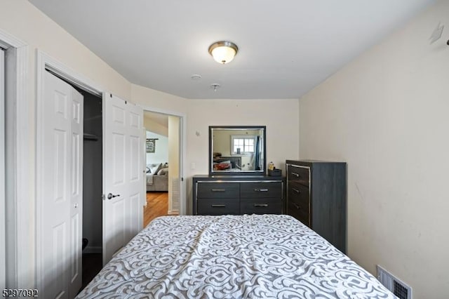 bedroom featuring wood finished floors and a closet