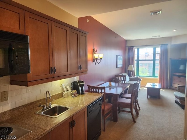 kitchen with black appliances, sink, decorative backsplash, light stone countertops, and light colored carpet