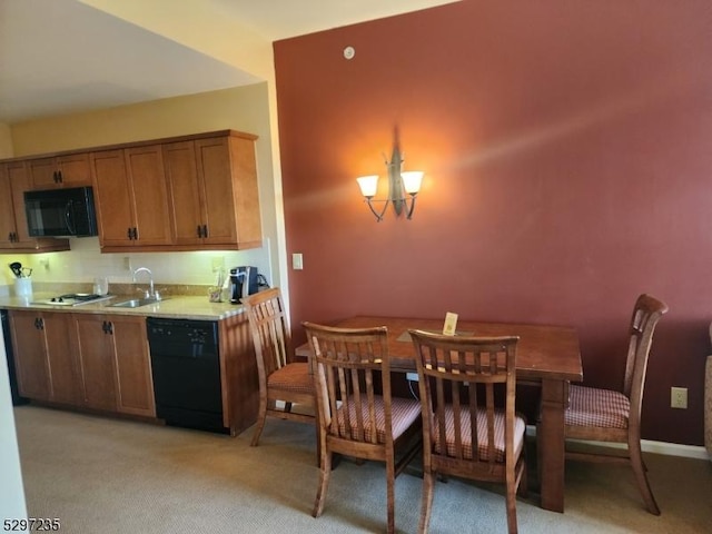 kitchen featuring a chandelier, light carpet, sink, and black appliances